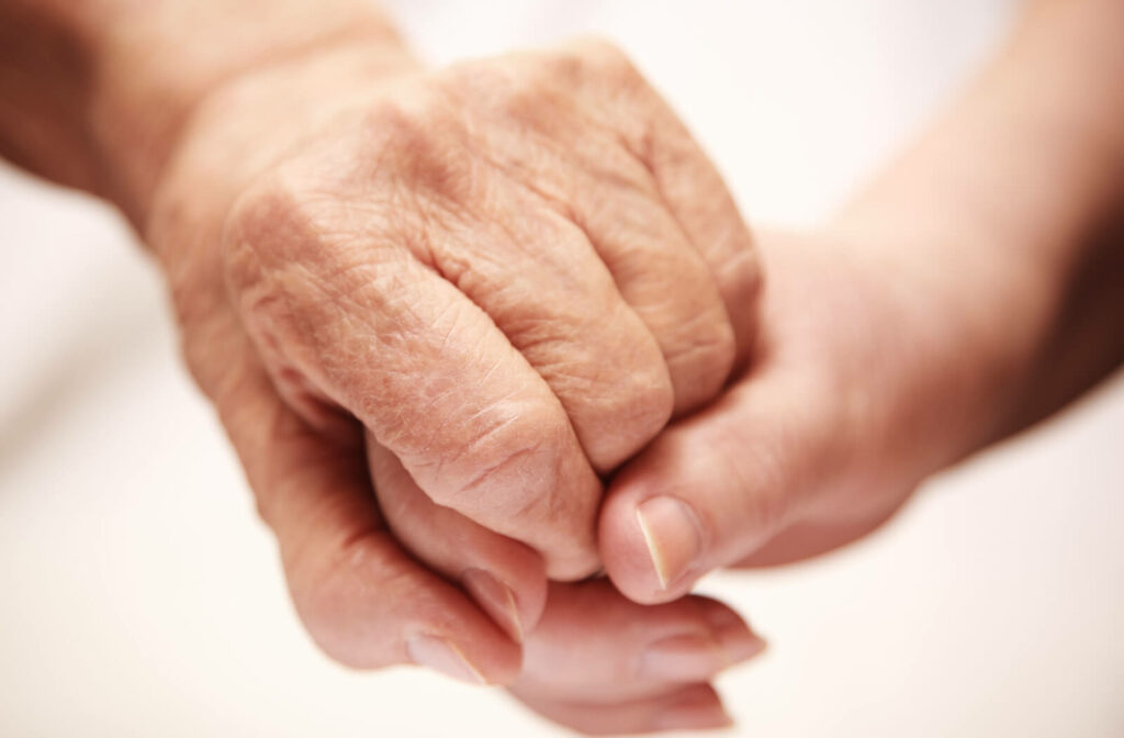 a young hand holding a senior hand