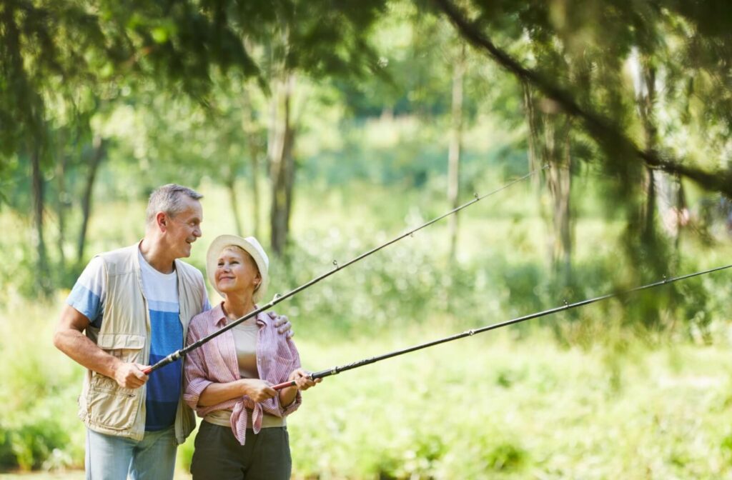 2 older adults smiling and fishing together